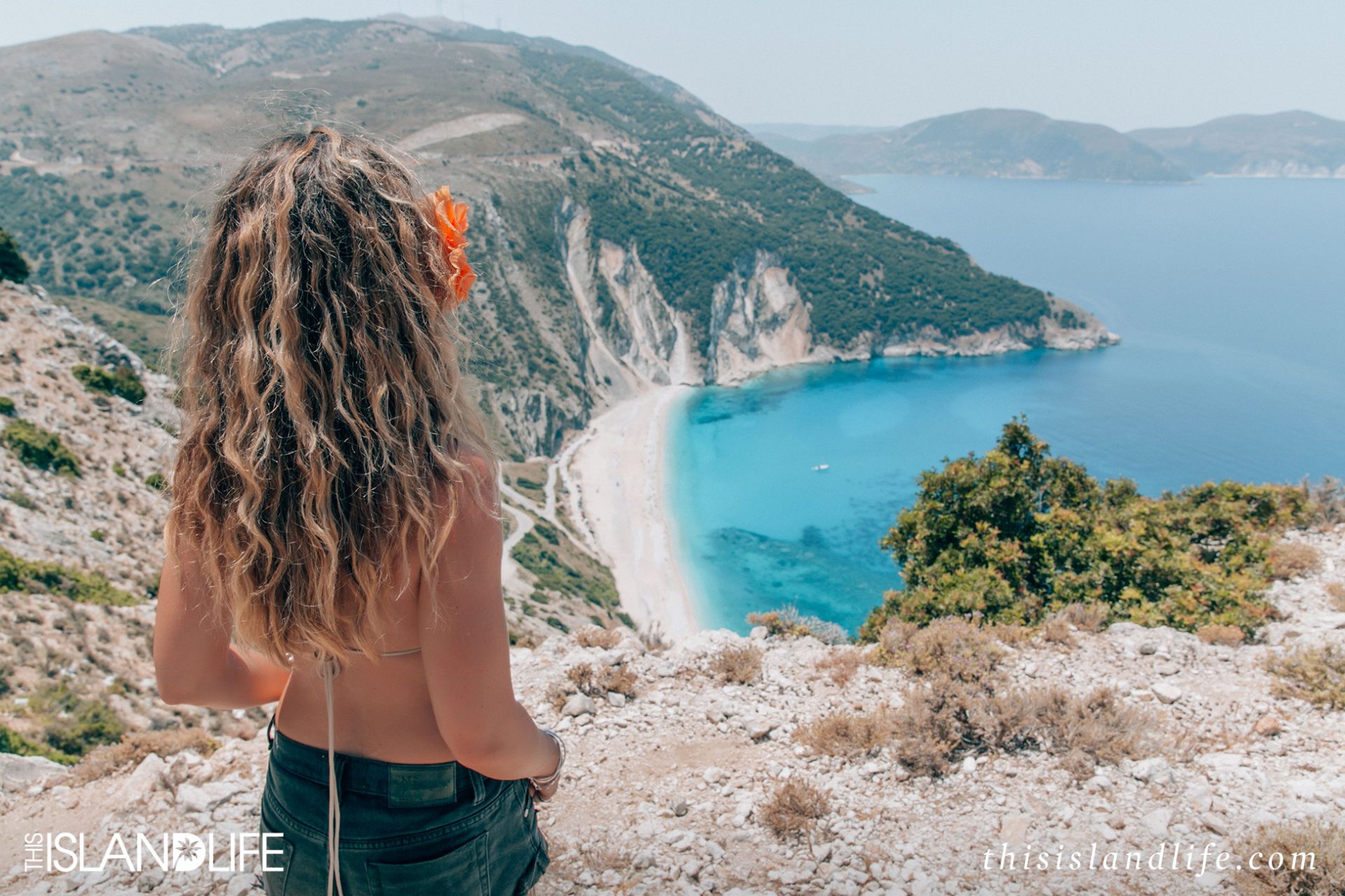 Girl looking at Myrtos Beach view on Kefalonia, Ionian Islands, Greece
