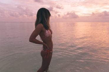 Girl in bikini at sunrise on Bawah Island